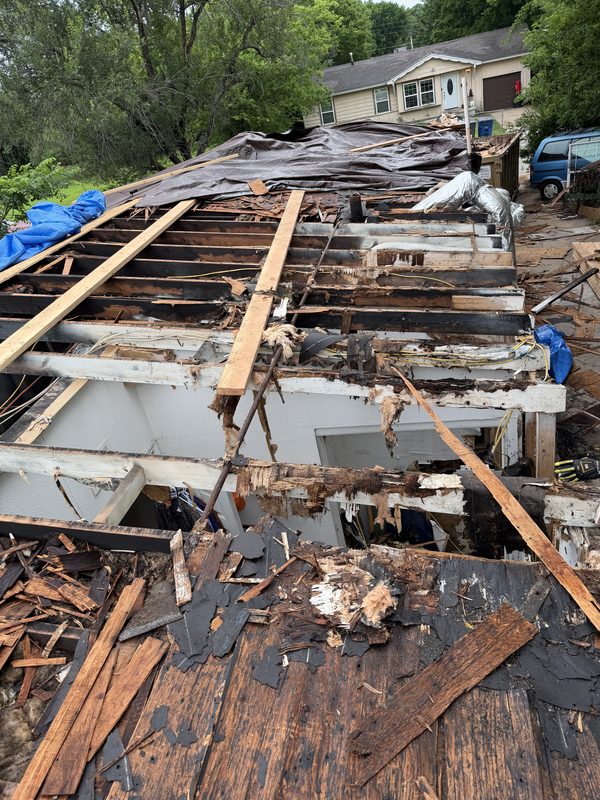 Old roof torn off down to rotted, damaged decking and exposed rafters